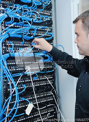 Image of young it engeneer in datacenter server room