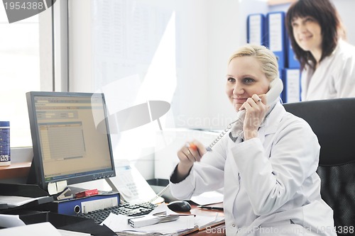 Image of pharmacy worker talking by phone