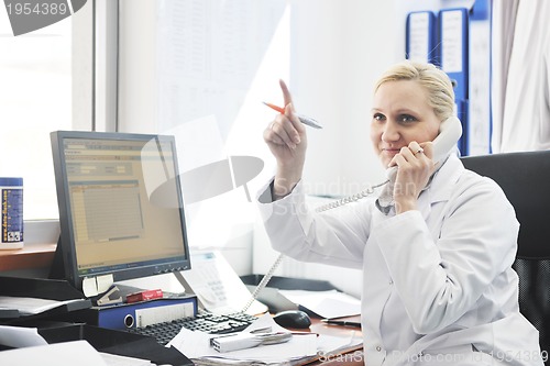 Image of pharmacy worker talking by phone