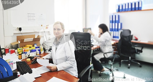 Image of pharmacy worker talking by phone