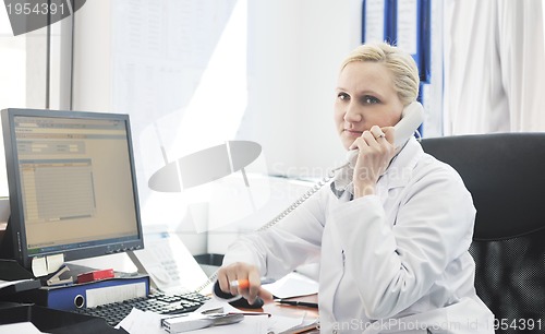 Image of pharmacy worker talking by phone