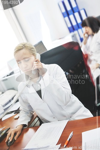 Image of pharmacy worker talking by phone