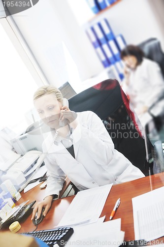 Image of pharmacy worker talking by phone