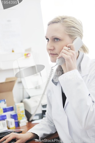 Image of pharmacy worker talking by phone
