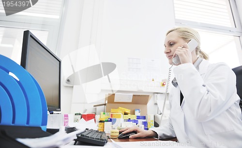 Image of pharmacy worker talking by phone