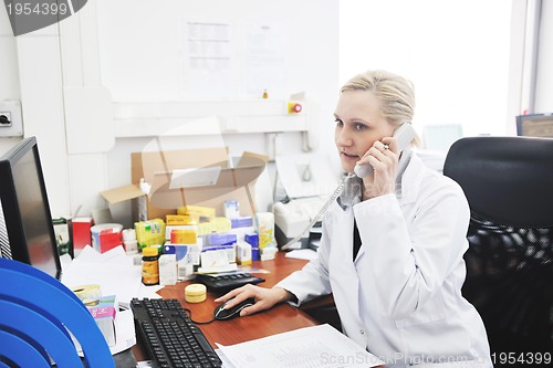 Image of pharmacy worker talking by phone