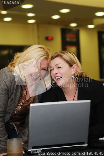 Image of happy mature woman work on laptop