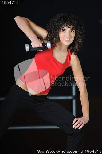 Image of youg woman workout in fitness club with dumbbell