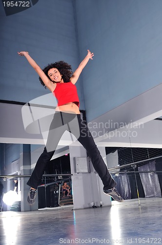 Image of young woman jumping indoor