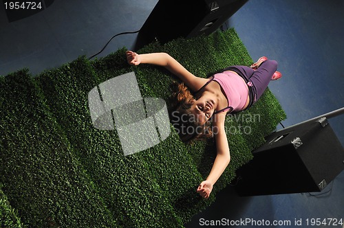 Image of young woman relax on green stairs with grass surface