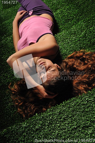 Image of young woman relax on green stairs with grass surface