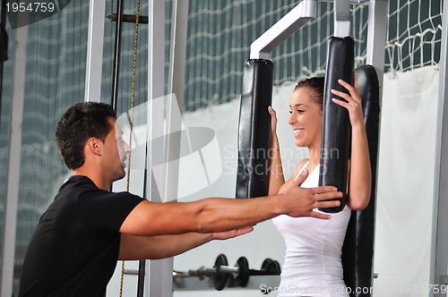 Image of woman in fittness club with trainer