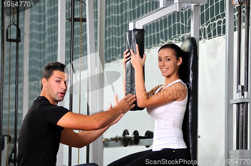 Image of woman in fittness club with trainer