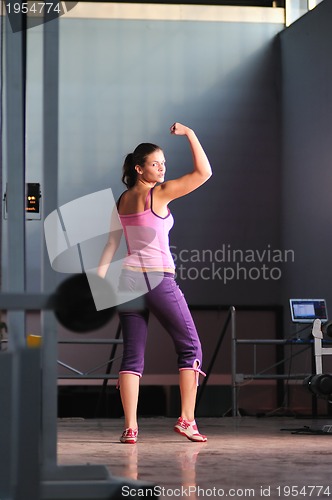 Image of young woman with strong arms rising hands in air