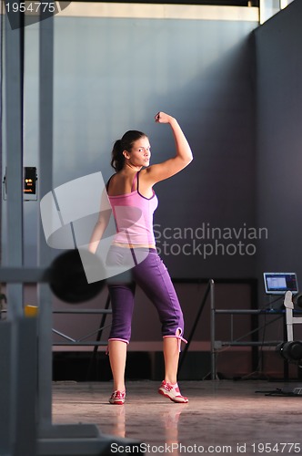 Image of young woman with strong arms rising hands in air