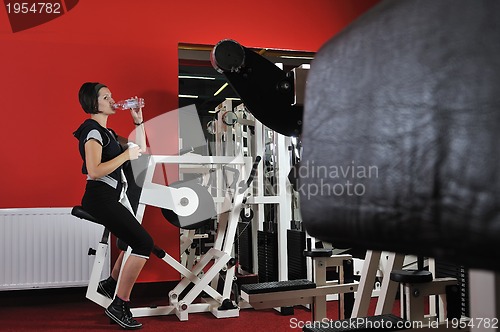 Image of Young woman doing fitness in gym