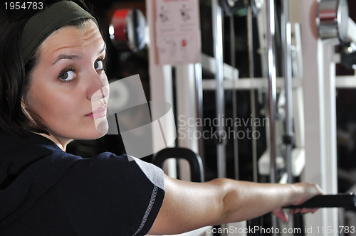 Image of Young woman doing fitness in gym