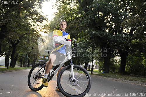 Image of Fit happy young man smiling on bike