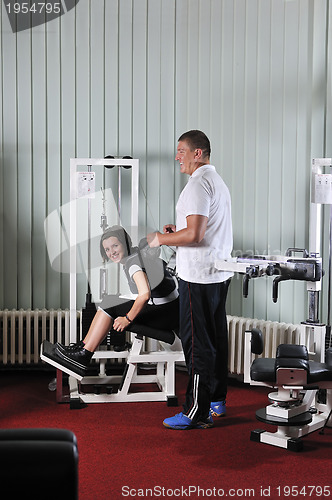 Image of Young woman doing fitness in gym