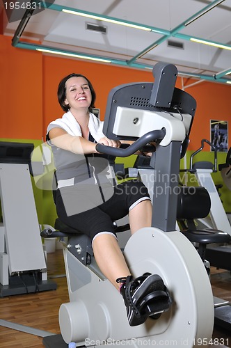 Image of Young woman working out in gym