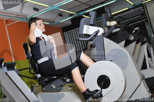 Image of Young woman working out in gym