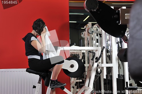 Image of Young woman doing fitness in gym