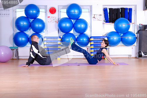 Image of .happy couple at gym working out