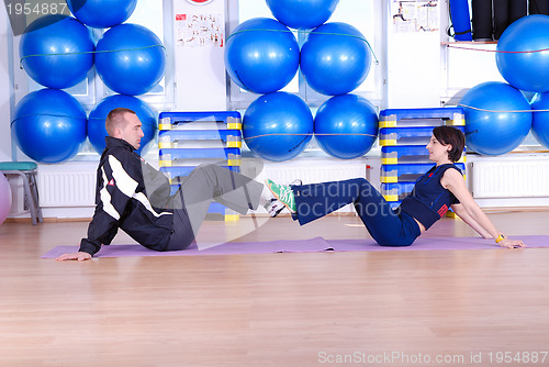 Image of .happy couple at gym working out