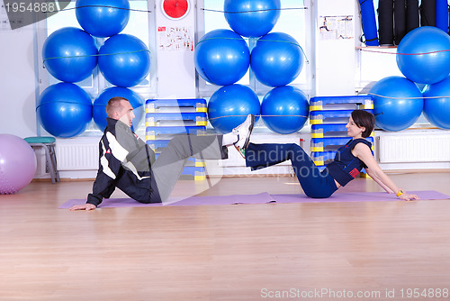 Image of .happy couple at gym working out