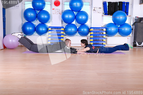 Image of .happy couple at gym working out