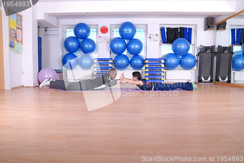 Image of .happy couple at gym working out