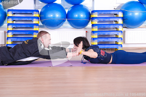 Image of .happy couple at gym working out