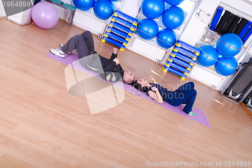 Image of .happy couple at gym working out