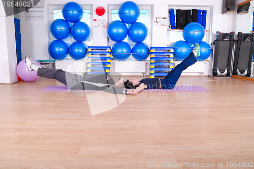 Image of .happy couple at gym working out