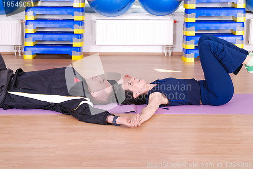 Image of .happy couple at gym working out