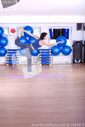 Image of .happy young woman exercising in a gym