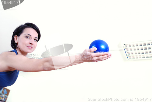 Image of .happy young woman exercising in a gym