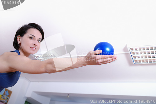 Image of .happy young woman exercising in a gym