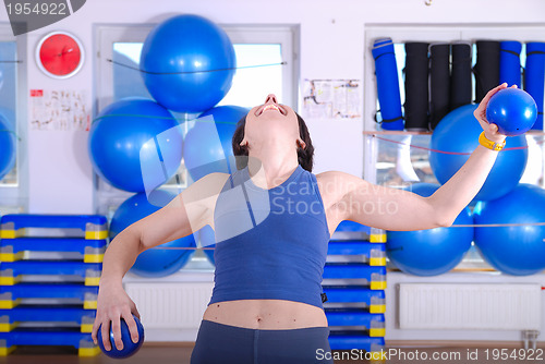 Image of .happy young woman exercising in a gym