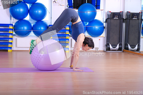 Image of .happy young woman exercising in a gym