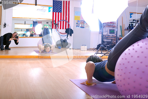 Image of .happy young woman exercising in a gym