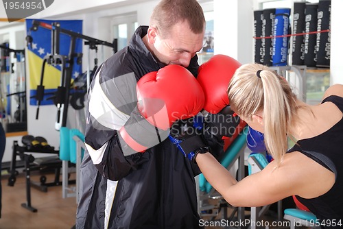Image of .woman and man box fighting