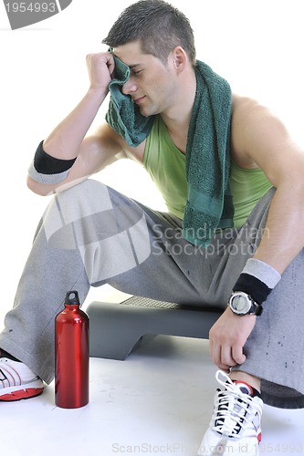 Image of sportsman relaxing and drinking water