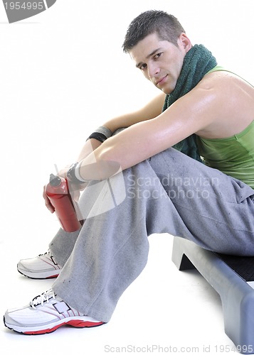 Image of sportsman relaxing and drinking water