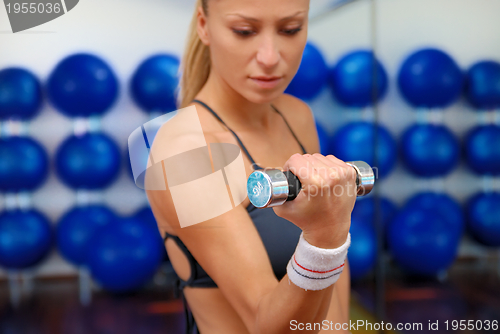 Image of woman doing exercise with dumbbell