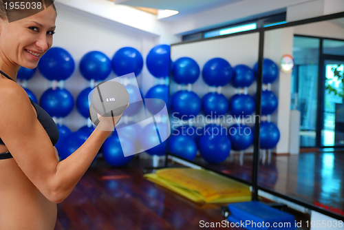 Image of woman doing exercise with dumbbell