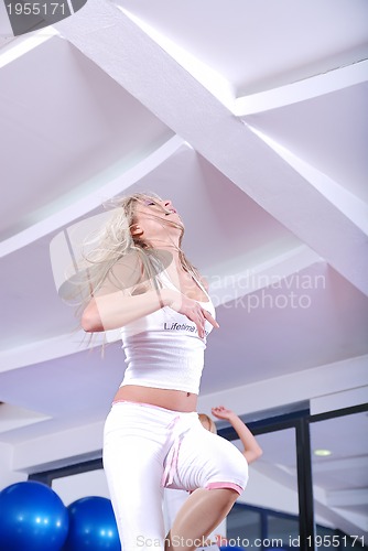 Image of attractive girl stepping in a fitness center