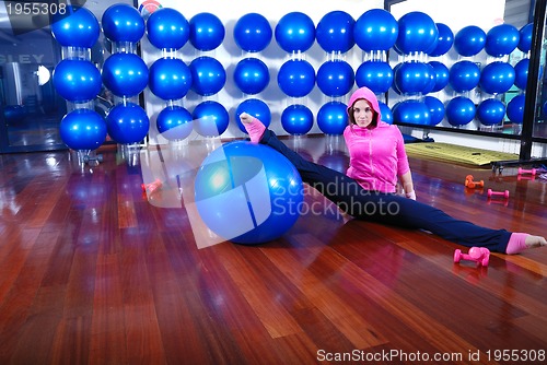 Image of young pretty woman exercising in a fitness center