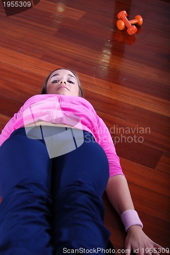 Image of young pretty woman exercising in a fitness center