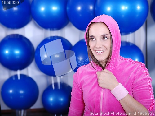 Image of young woman exercising with pilates ball